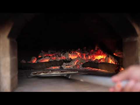 Wood fired brick oven pizza cooking at Malikii Savory in Loei Thailand