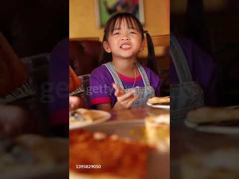 a 7-year-old girl's eating pizza, Asian girl, Thailand